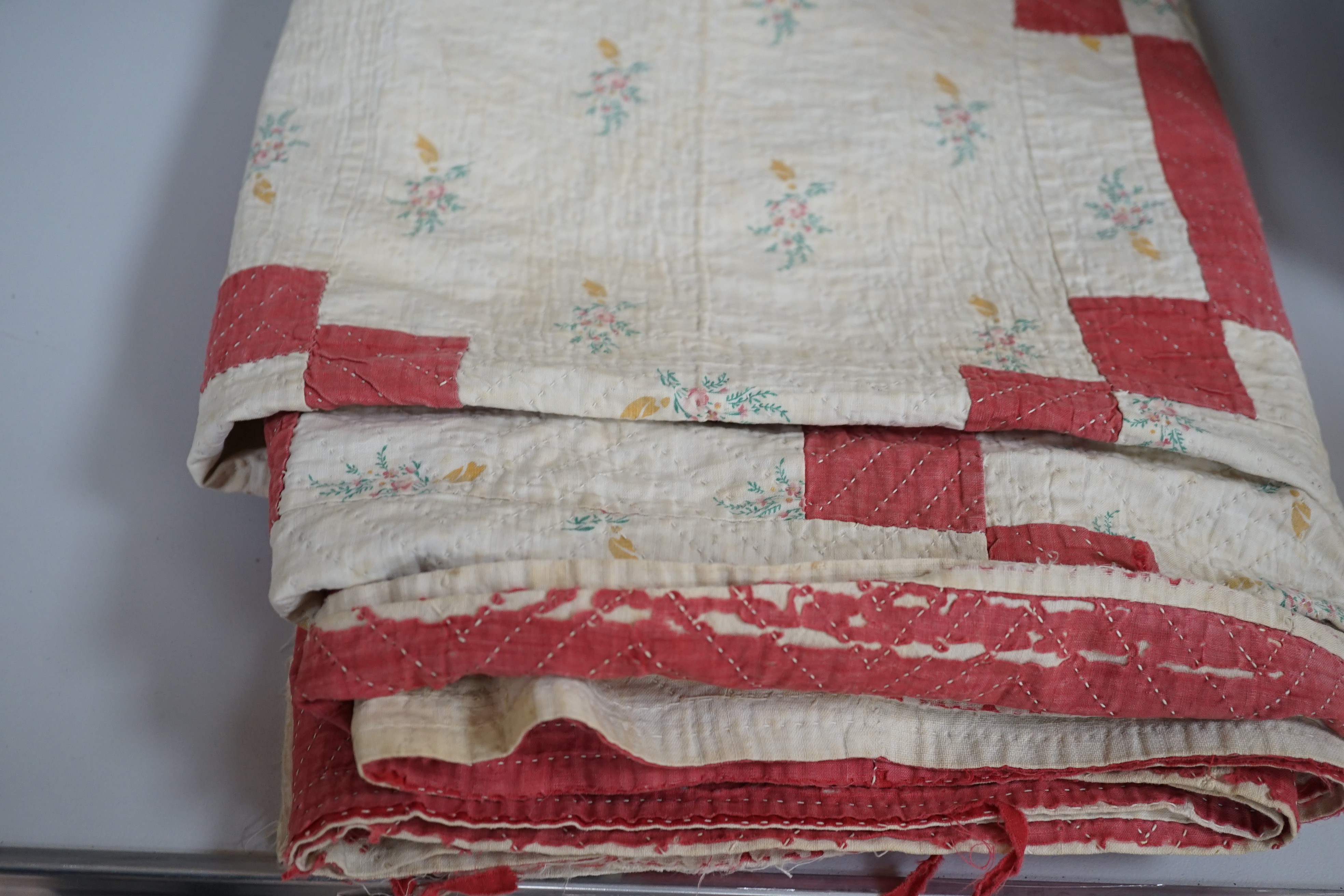 A mid to late 19th century hand stitched patch worked quilt, 210 cms x 200 cms